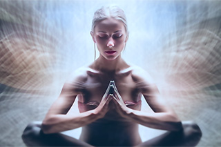 Meditating woman takes a mindful pause to connect with her intuitive guidance